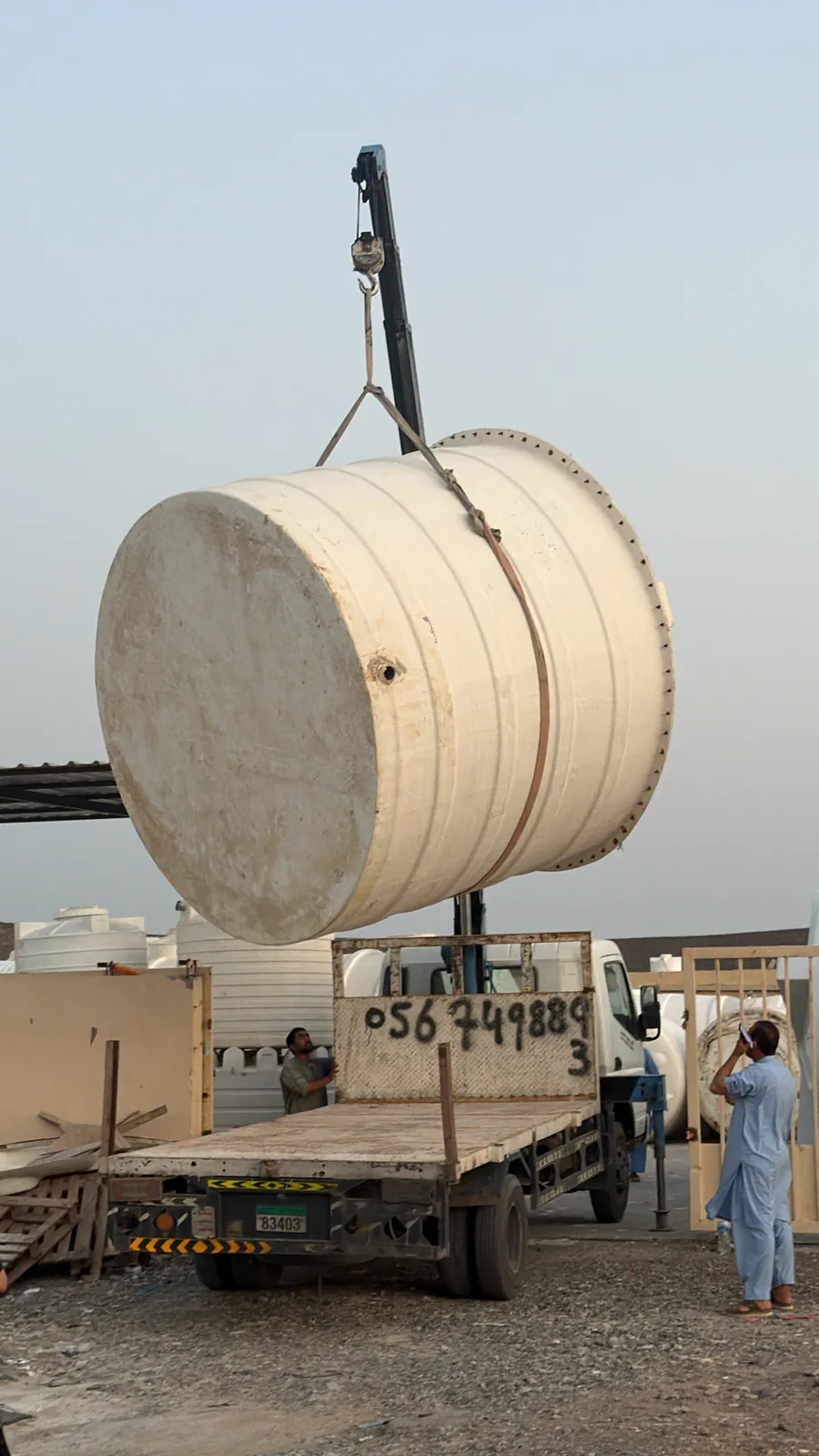 GRP water tank being craned onto a flatbed for delivery