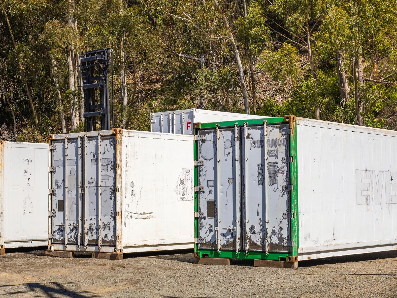 Plain white 20ft containers standing on a compound