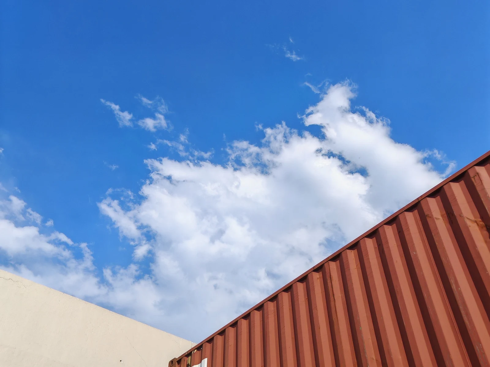 An unmarked container against open sky
