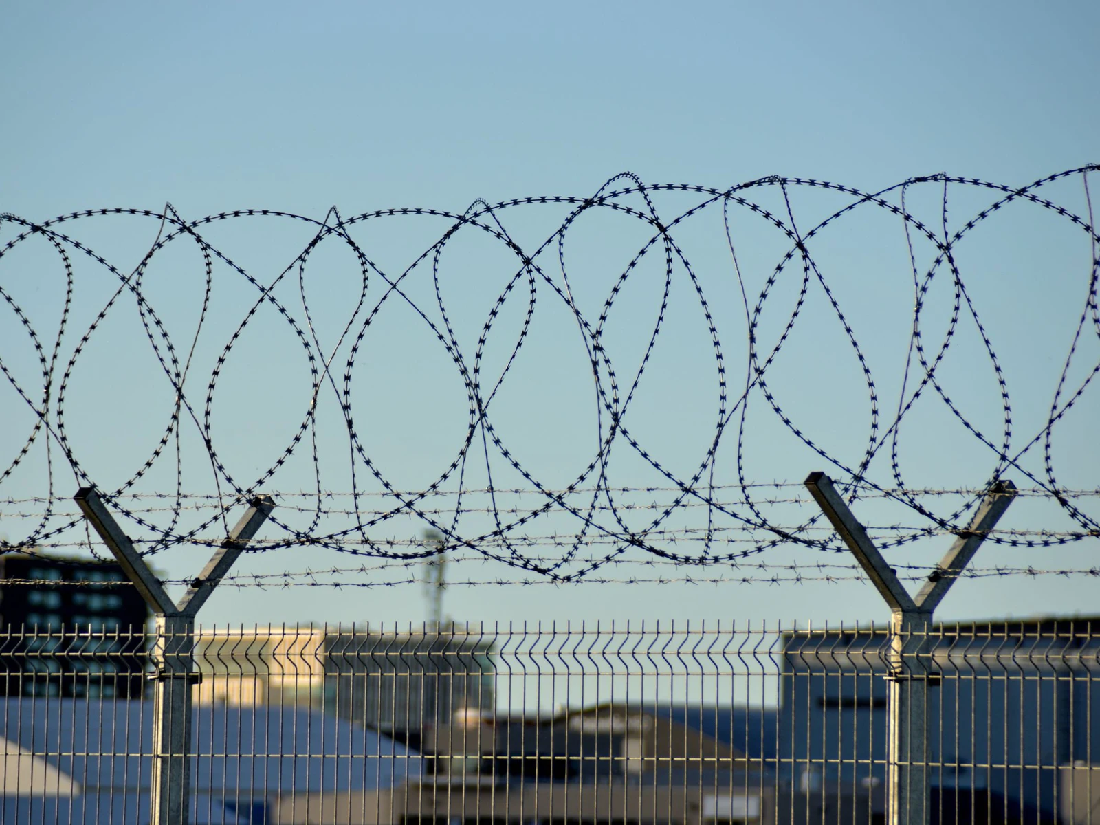 Razor coil above a secure perimeter fence