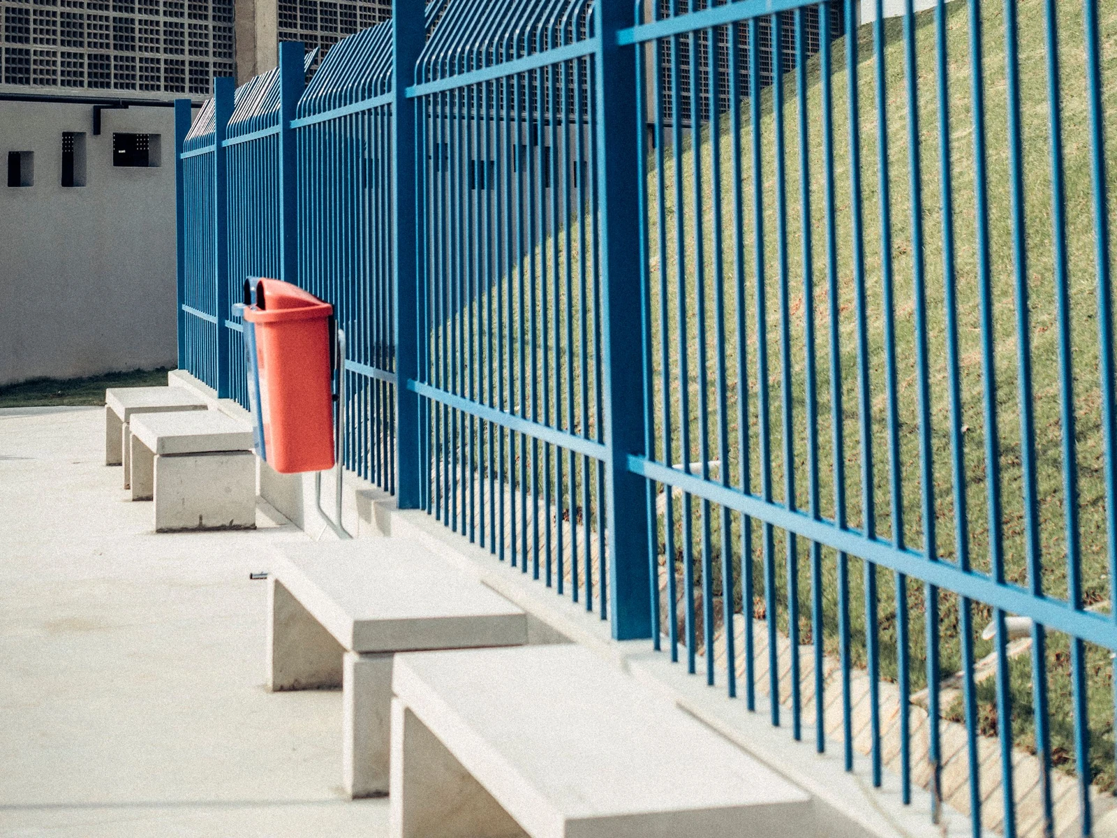 Palisade fencing with trident tops along a plant