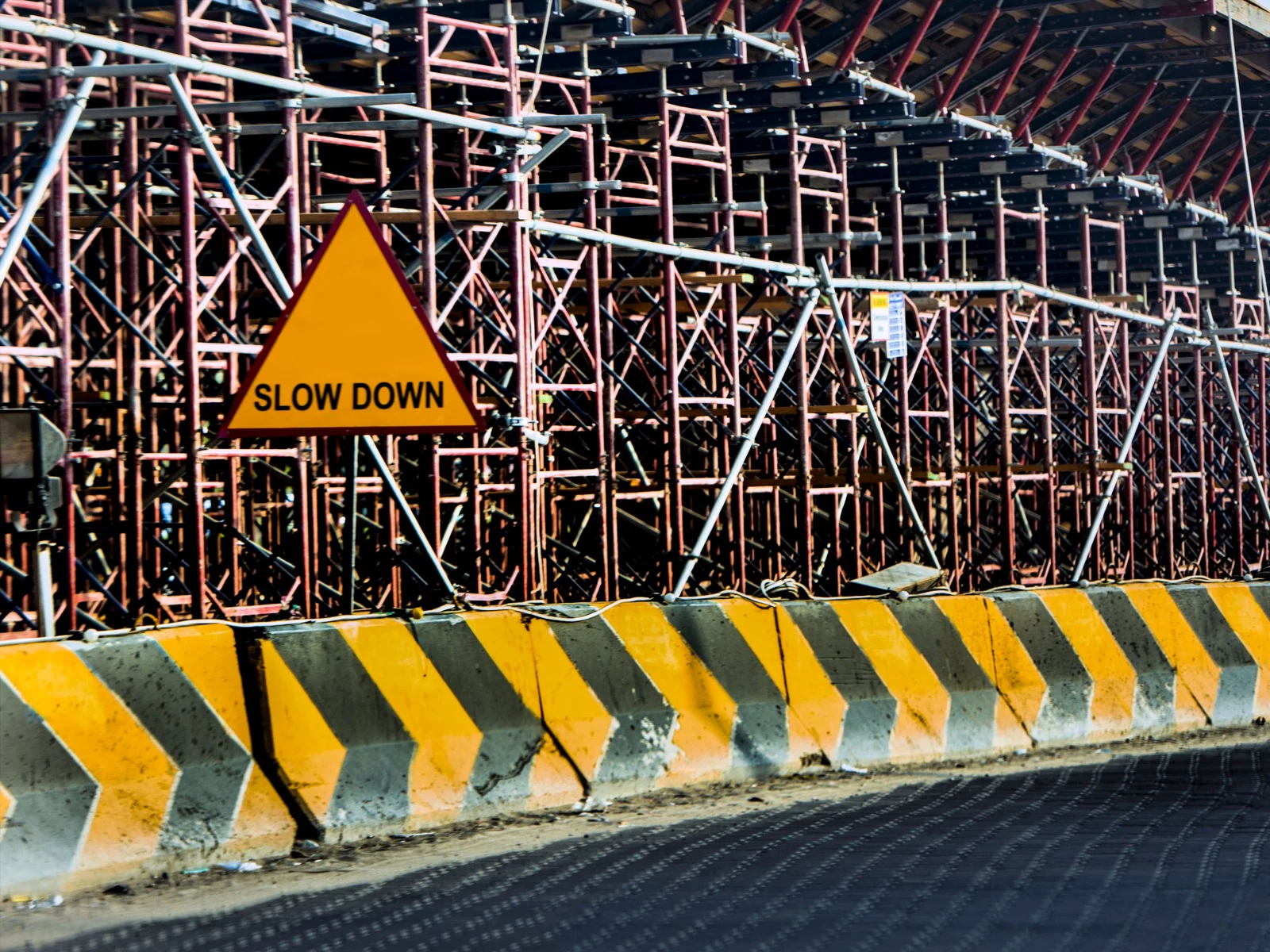 A site board set against the works it warns of