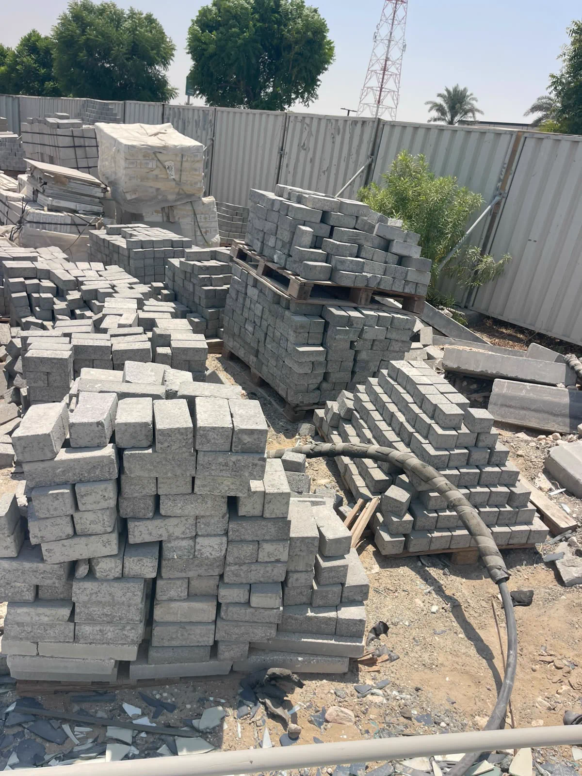 Kerb stones and interlock pavers stacked in the yard